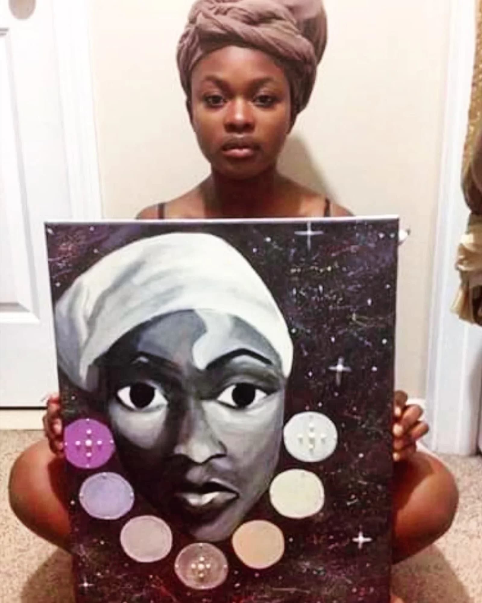 Ivey holding a black and white portrait edged with beads